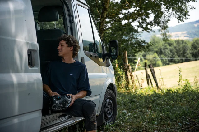 A rider sitting in the doorway of a van at Backyard Battle