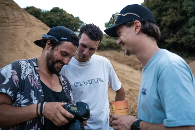 Friends looking at a camera together at Paul Couderc’s Backyard Battle