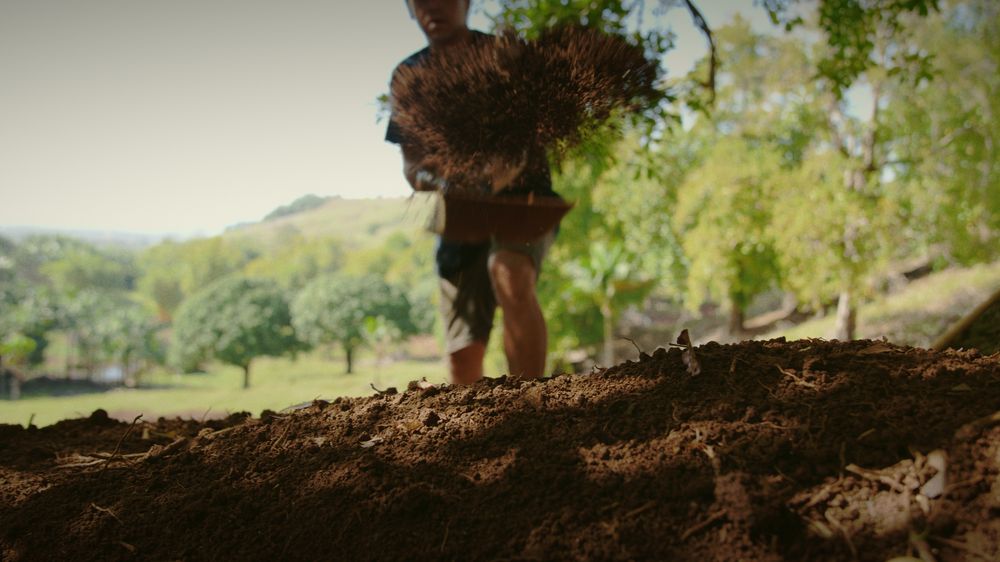 Earth flies from a shovel towards the camera