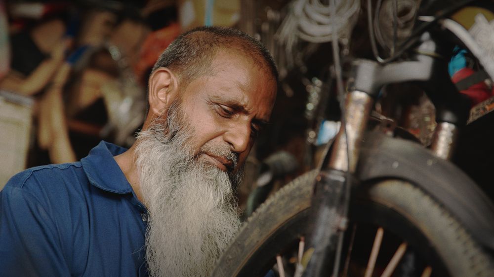 Close portrait of the mechanic, eyes on his work